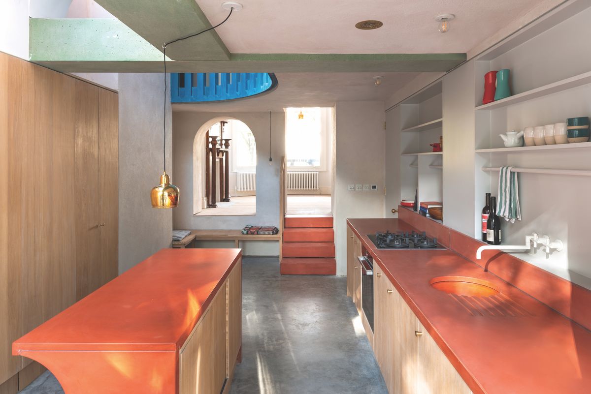 colourful kitchen in terrace house with red island