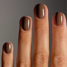 A close-up of @matejanova's hand, with her nails painted in Manucurist's Mocha nail polish shade