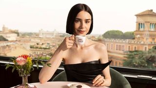 Lily Collins poses in Rom with a cup of espresso with the show's logo on it