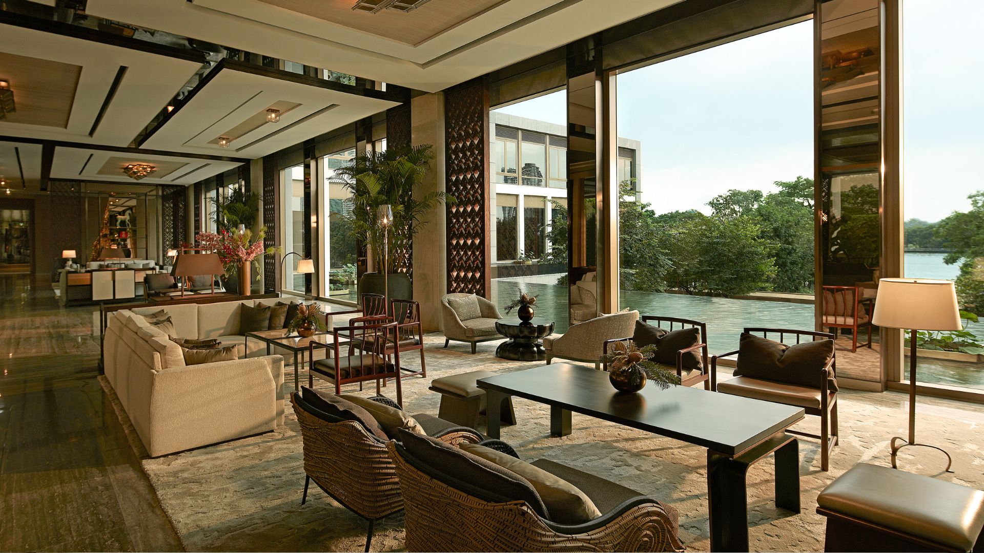 Capella Bangkok tea lounge with neutral chic furniture, views over a swimming pool and floor to ceiling windows