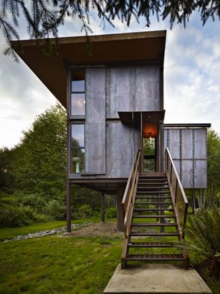 The house is elevated on four steel pillars