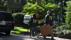 FBI agents carry boxes into John Bolton's home