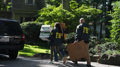FBI agents carry boxes into John Bolton's home