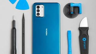 Nokia G22 phone in blue with iFixit tools surrounding it