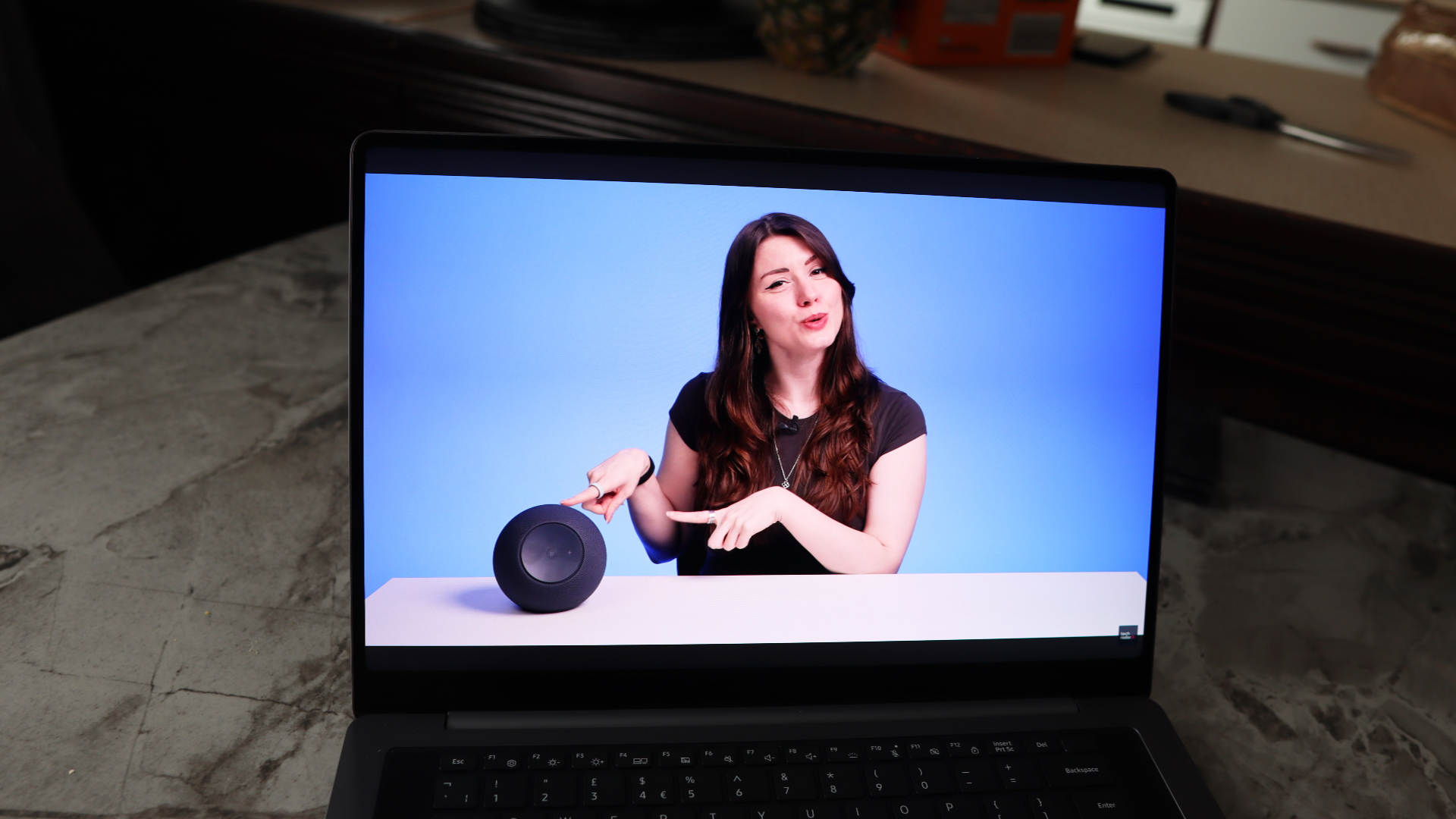 A laptop on a grey worktop surface.