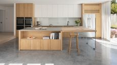 a kitchen with a polished concrete floor