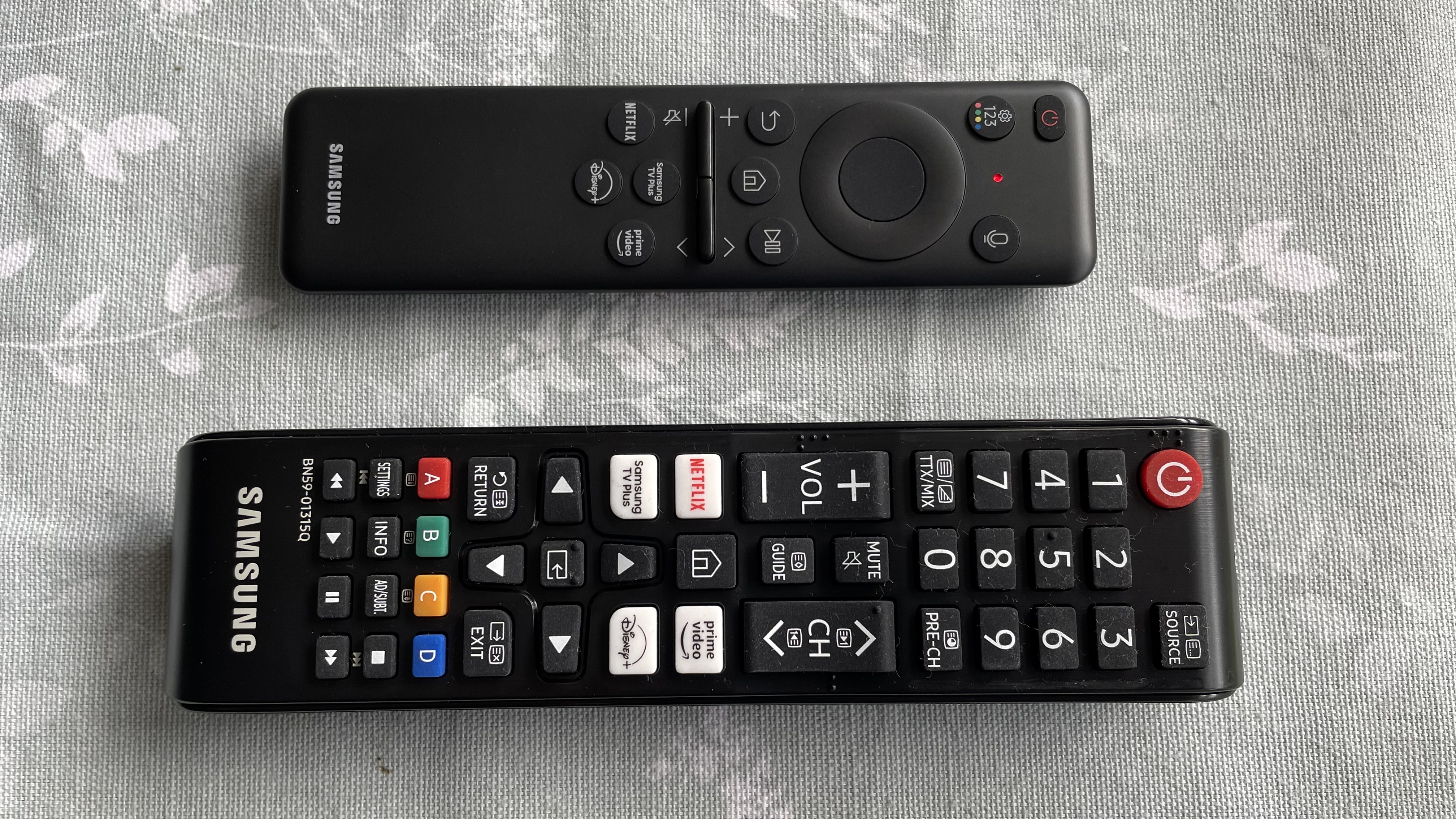 Samsung Q80D remote controls on table