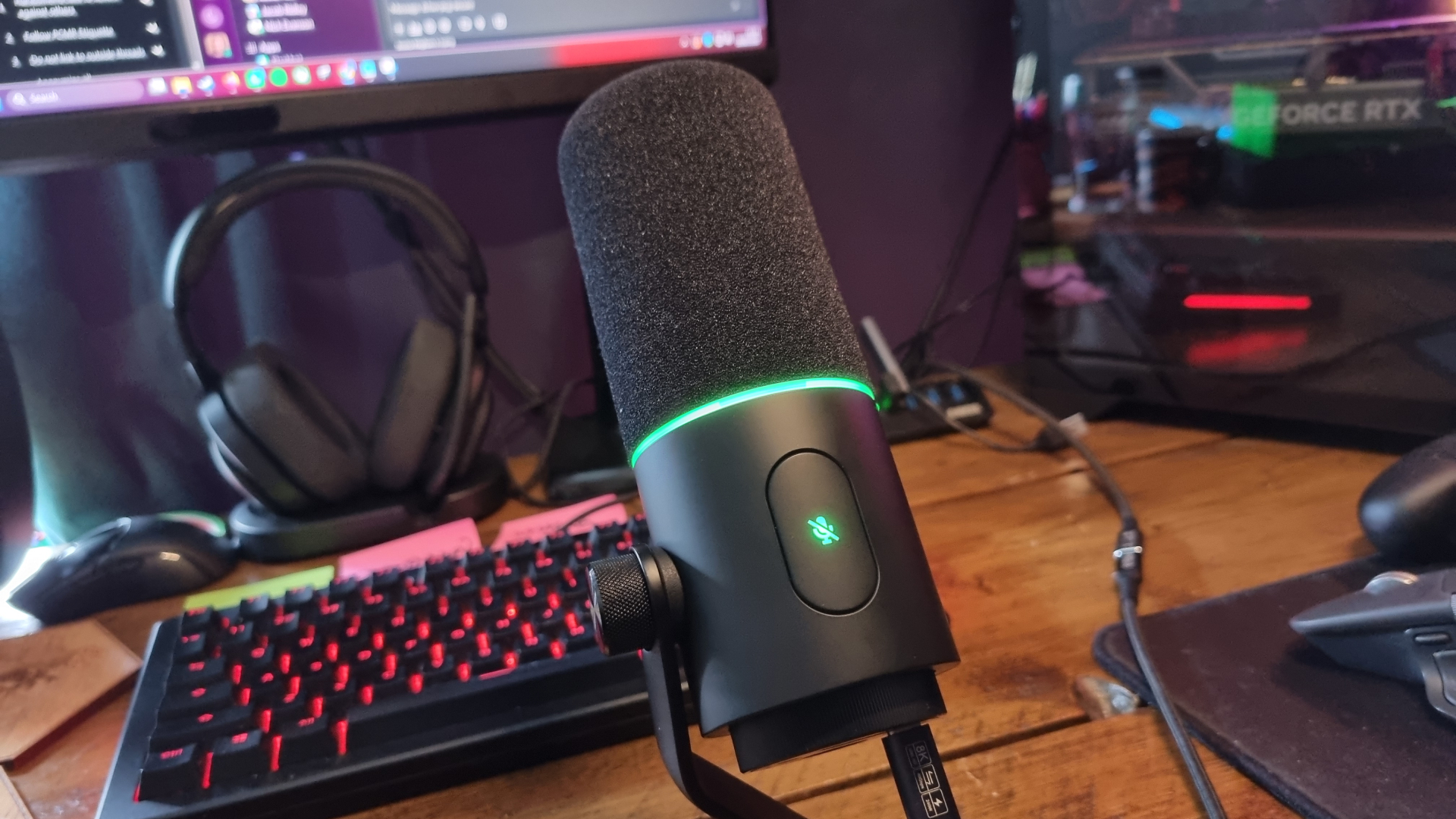 A Razer Seiren V3 Pro microphone on a desk, in front of a gaming keyboard