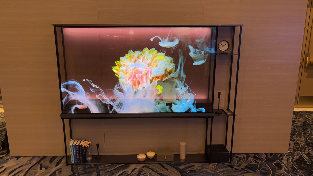 LG OLED T transparent TV against a wooden wall background
