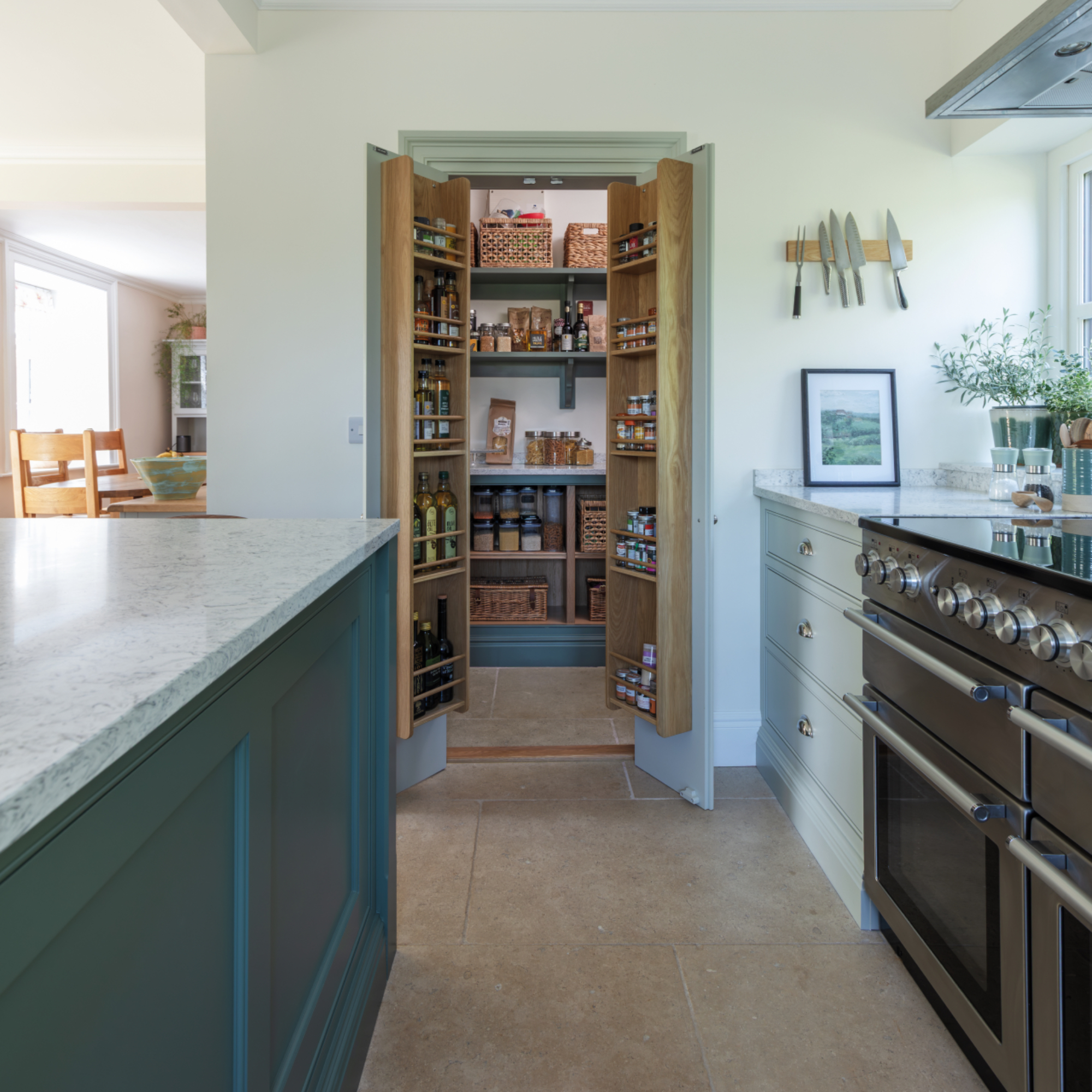 pantry in kitchen with view inside and shelving on doors