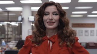 Esmeralda smiling at the camera in The Paper episode 1