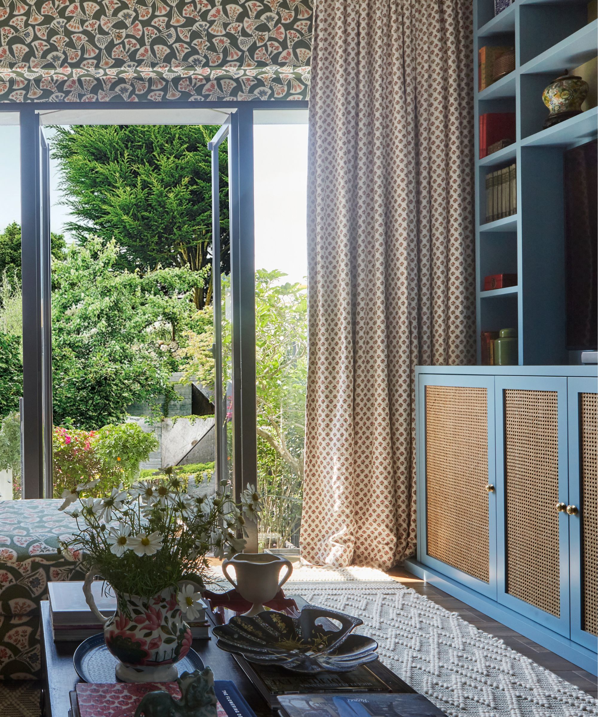 a patterned drenched snug room with a blue media wall unit