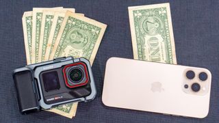 Insta360 Ace Pro 2 on a pile of dollar bills and an iPhone on a single dollar bill