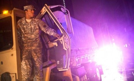 A soldier looks out form his military vehicle during the landfall of Hurricane Sandy in lower manhattan on Oct. 29.