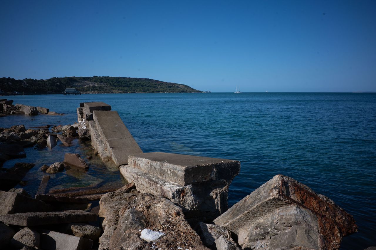 Destroyed sea wall on a sunny day