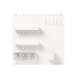 A white pegboard with shelves and boxes on it