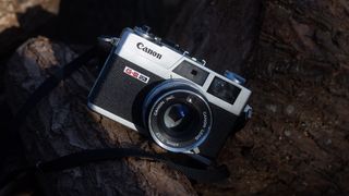 Canon Canonet G-III QL17 camera on a log