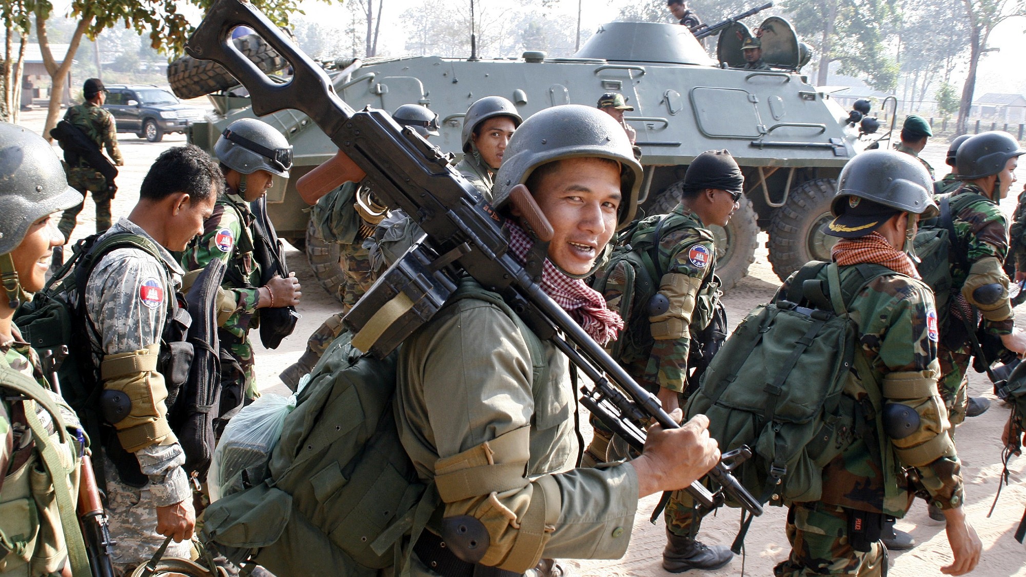 Cambodian soldiers and an infantry carrier vehicle on the move