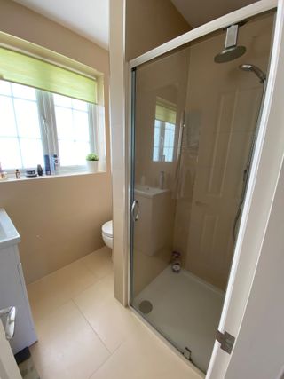 Beige bathroom tiles with terrazzo stencil in white and black pattern