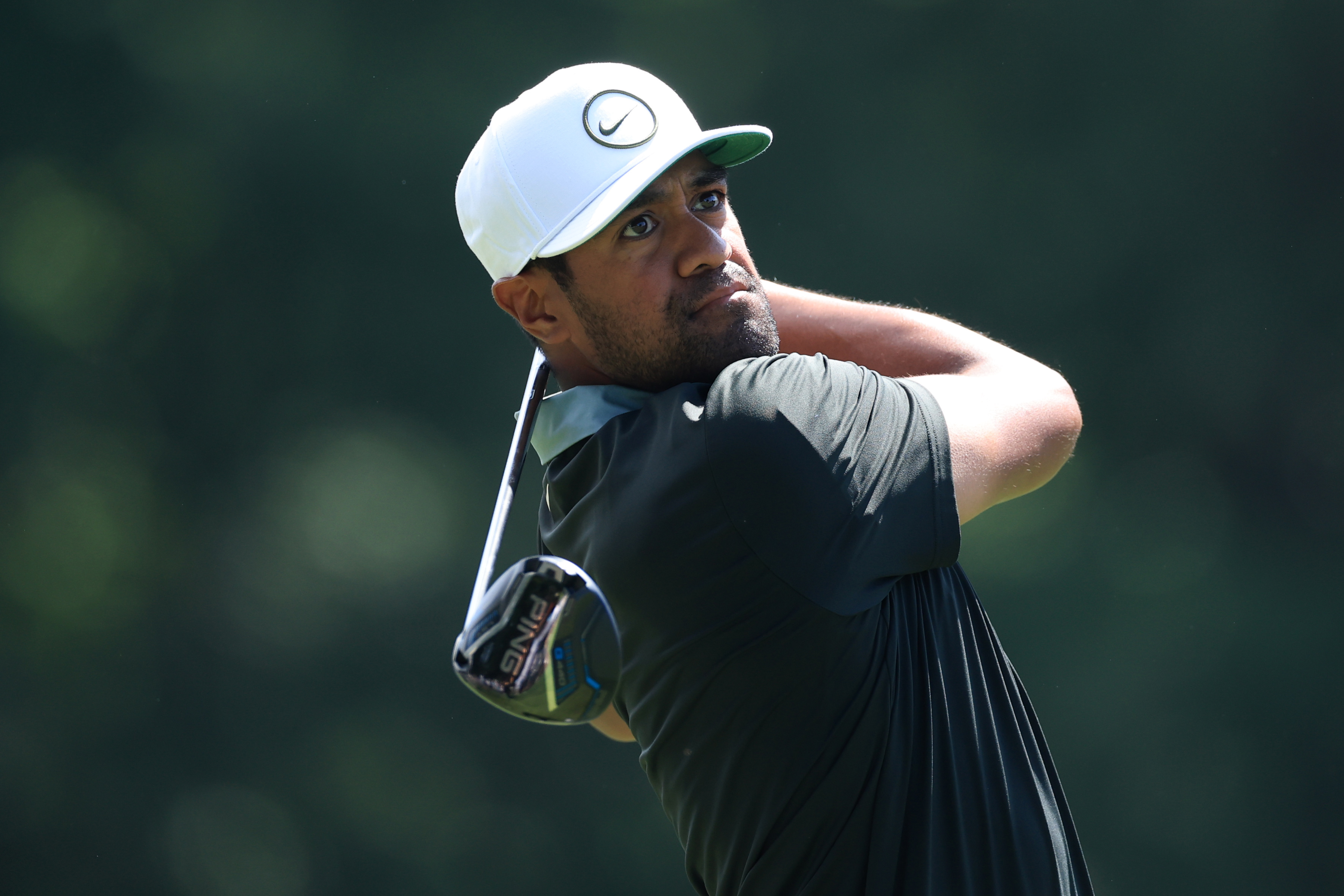 Tony Finau hits a driver off the tee and watches the flight of it