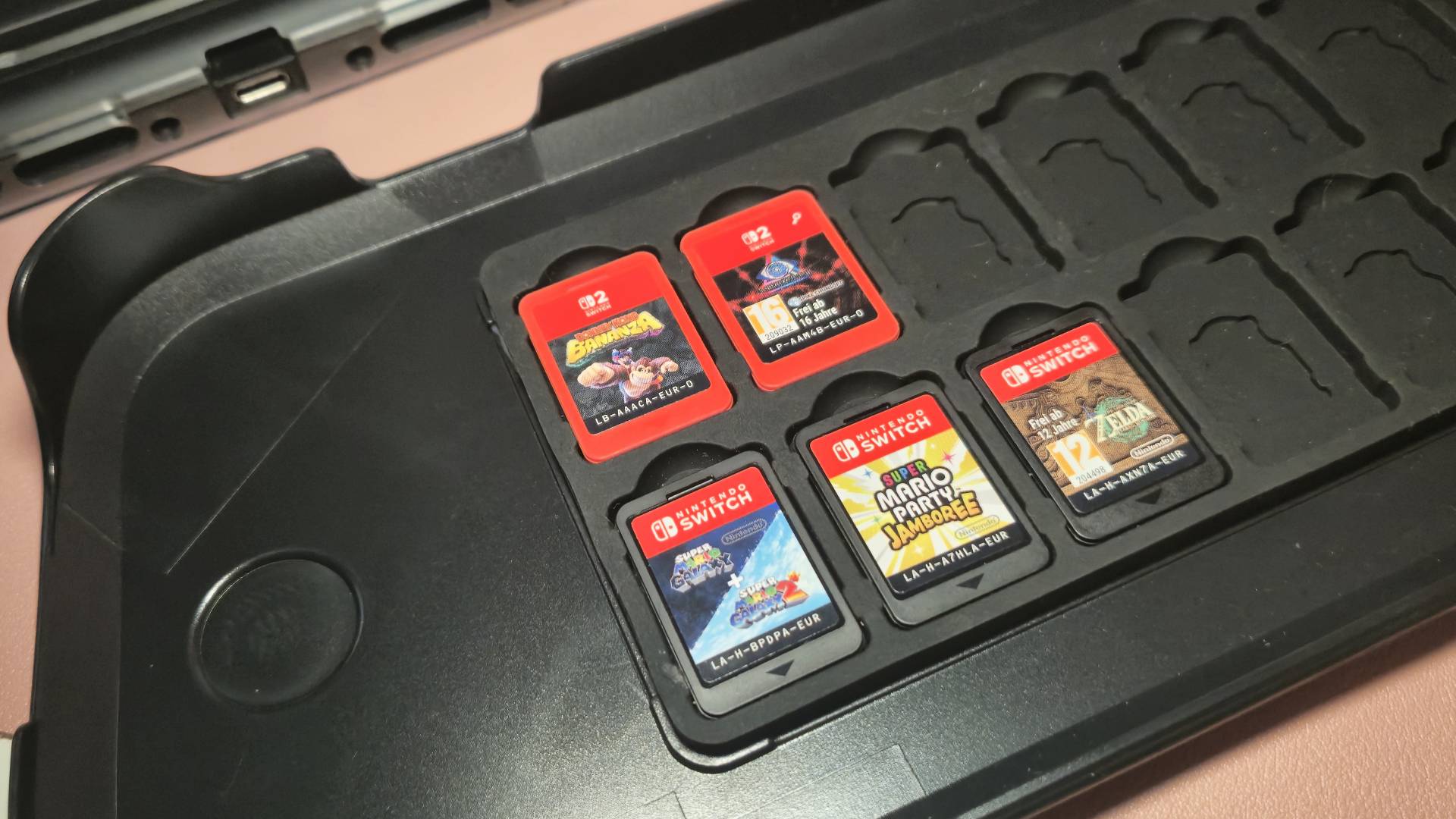 Photo of Switch 2 and Switch games sitting in the Fastsnail Switch 2 case.