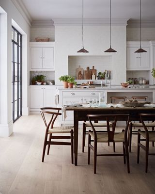 country kitchen diner with dining table, chairs and white cabinetry