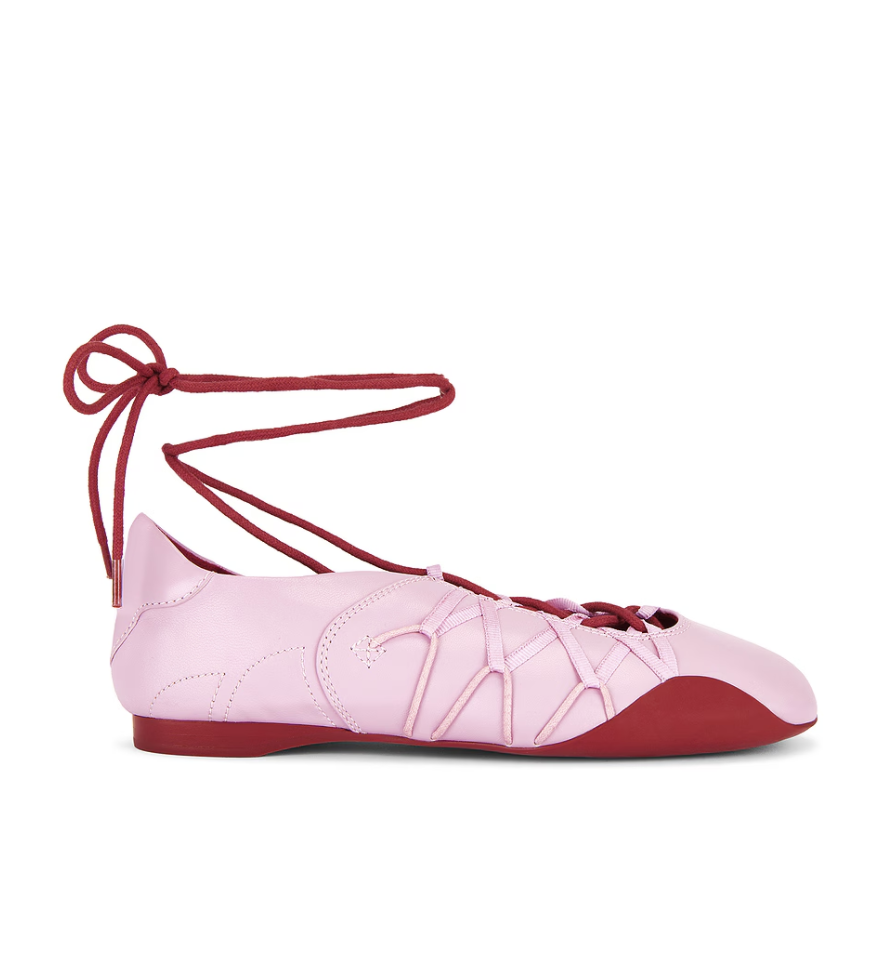 a pair of jeffrey campbell ballet sneakers in front of a plain backdrop