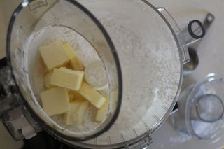 Cold butter in the chopping bowl of the Cuisinart Custom