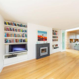 living space with wooden flooring and book shelf
