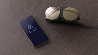 A top-down product render of the HTC Vive Flow showing the headset sat next to a smartphone with the words Sync displayed