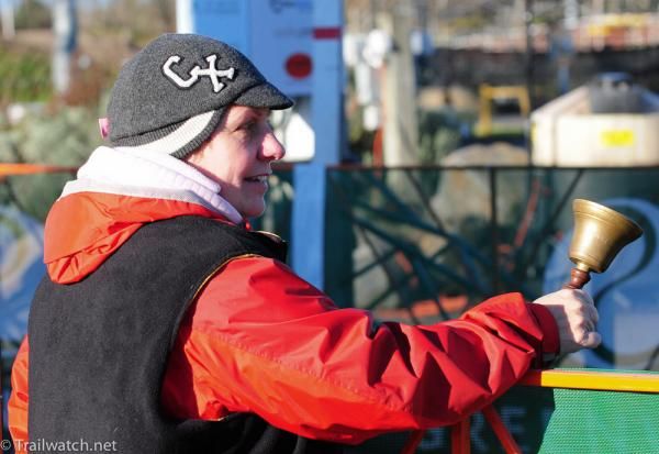 An official ringing the official bell for the final lap.