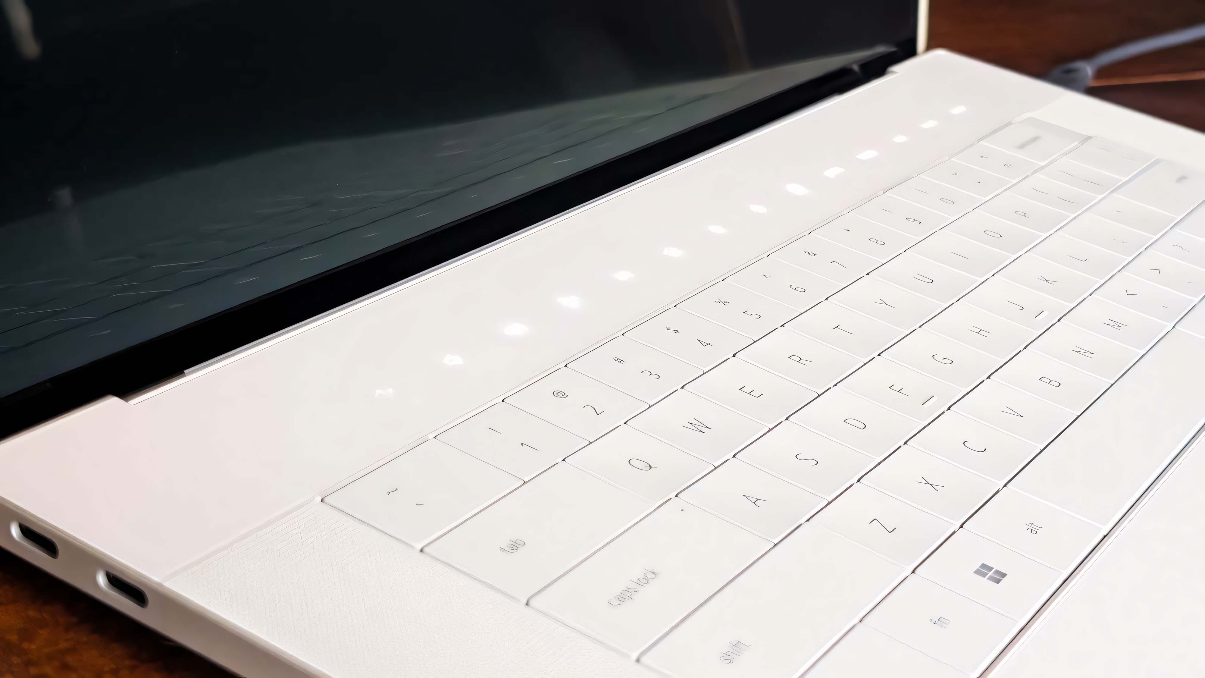 A closeup of the Dell 16 Premium's capacitive buttons above the keyboard.