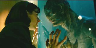 Sally Hawkins and Doug Jones stare at each other through the glass in The Shape of Water.