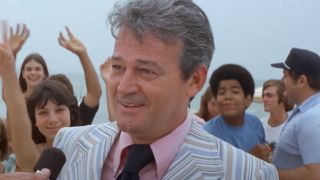 Murray Hamilton seen in an interview in front of a crowded beach in Jaws.