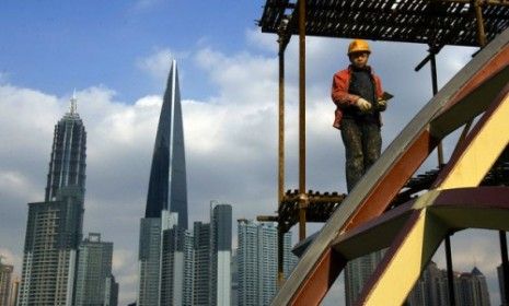 A construction worker climbs a scaffolding at the Shiliupu port in Shanghai, China.