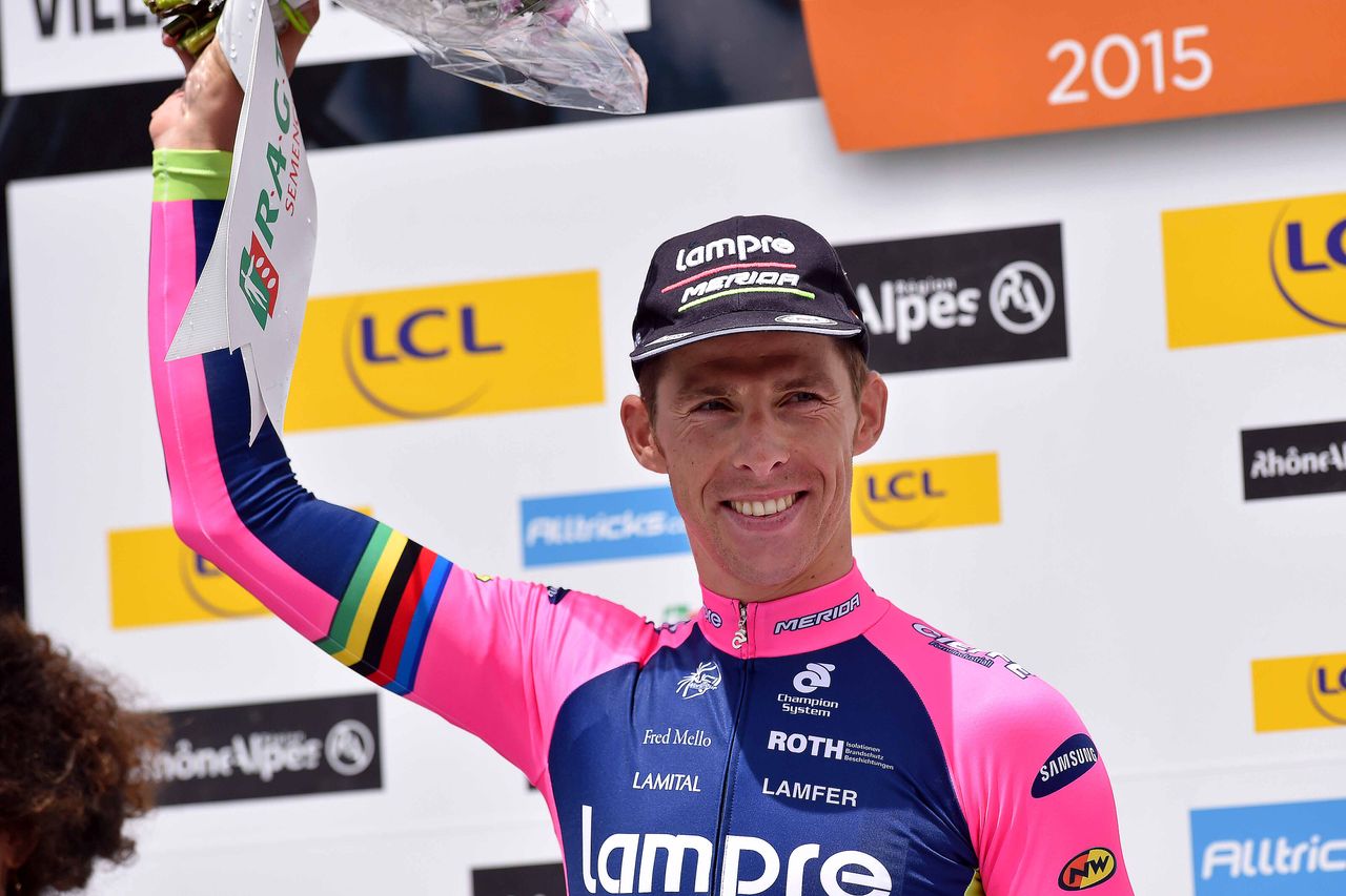 Rui Costa steps onto the podium to claim his prize