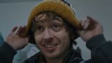Bryan from Resident Evil putting on a hat