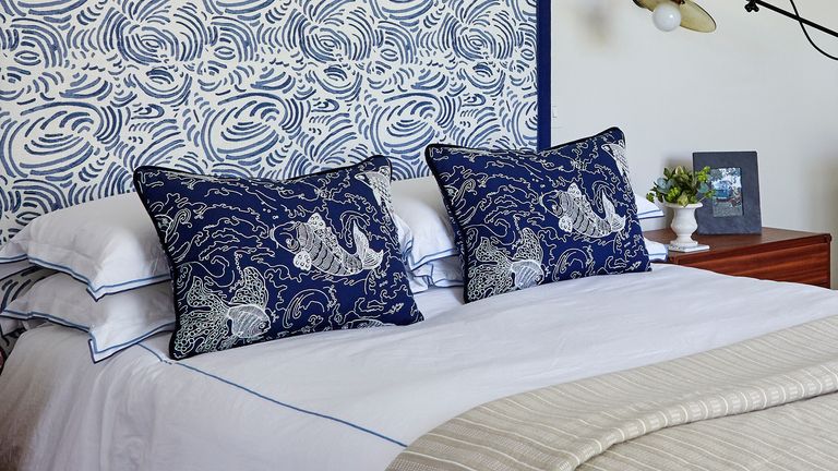 How to wash pillows – bed with patterned headboard and white and blue patterned pillows