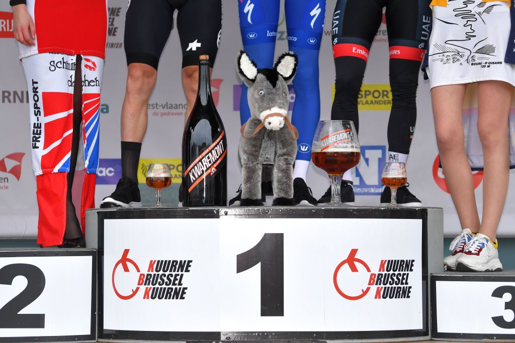 KUURNE BELGIUM MARCH 01 Podium Giacomo Nizzolo of Italy and Team NTT Pro Cycling Kasper Asgreen of Denmark and Team DeceuninckQuickstep Alexander Kristoff of Norway and UAE Team Emirates Celebration Miss Hostess Legs Beer Donkey Trophy Champagne Detail view during the 72nd KuurneBrusselKuurne 2020 a 201km race from Kuurne to Kuurne KBK20 KuurneBxlKuurne KBK on March 01 2020 in Kuurne Belgium Photo by Tim de WaeleGetty Images