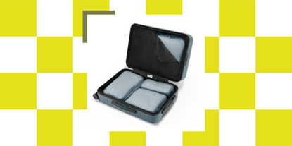 A blue suitcase with blue compression packing cubes