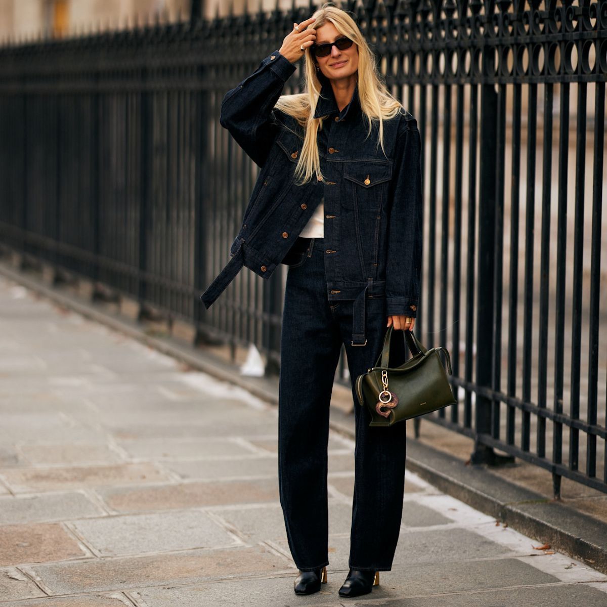 a woman wearing jeans during fashion week