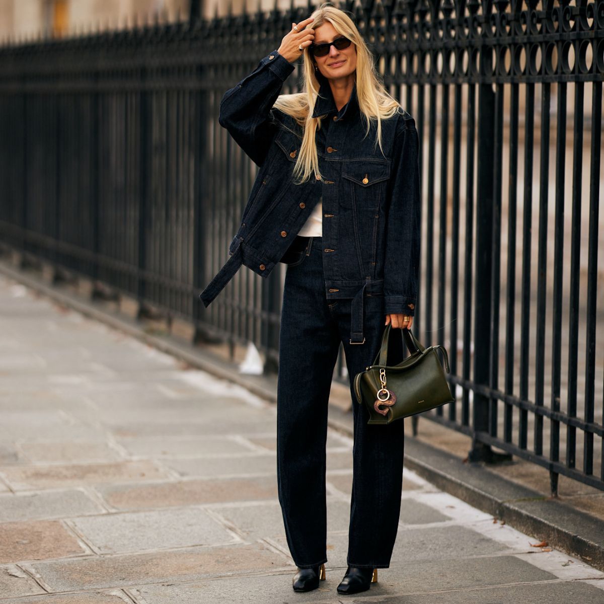 a woman wearing jeans during fashion week