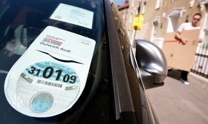 A 2008/ 2009 car tax disc is on display in a car windscreen on August 4, 2008 in London, England. Some MPs believe plans for new increased car tax rates on high fuel consumption vehicles shou