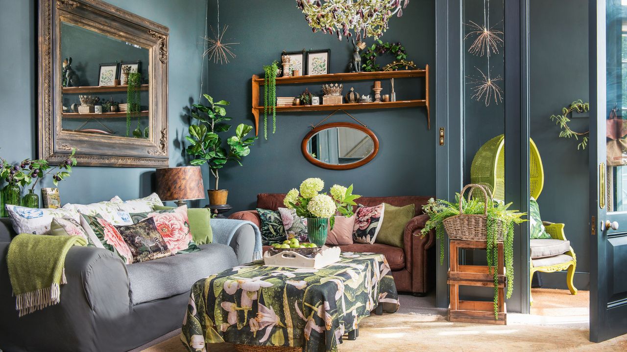 living room with dark grey walls, antique mirror, brown and grey sofa