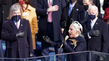 washington, dc january 20 lady gaga sings the national anthem at the inauguration of us president elect joe biden on the west front of the us capitol on january 20, 2021 in washington, dc during todays inauguration ceremony joe biden becomes the 46th president of the united states photo by alex wonggetty images