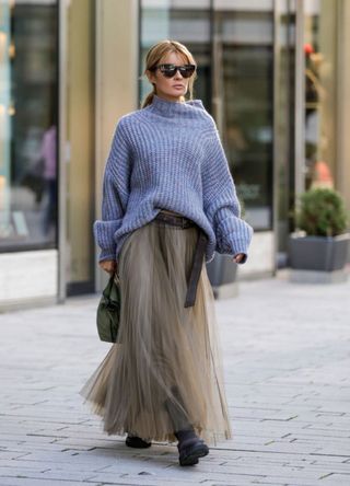 Gitta Bank in a slouchy knitted jumper and khaki tulle skirt