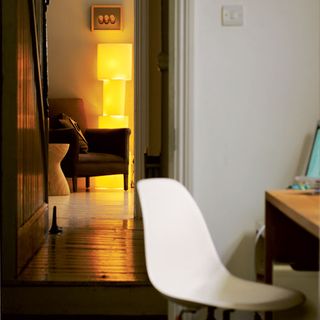 hallway with white chair and photoframe on wall