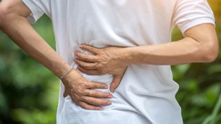 man with muscle knot in his back