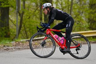 Cyclist is riding a red Pinarello