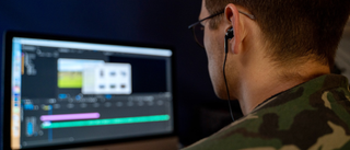 Man at computer using Adobe Premiere Pro video editing software